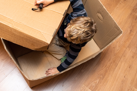 Child playing inside a cardboard box.の写真素材