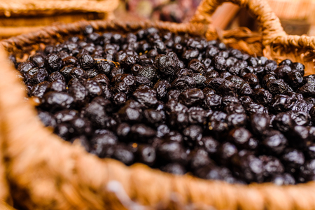Basket with nutritious dried black olives, snack typical of the Mediterranean countriesの写真素材