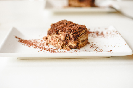 Biscuit and chocolate cake on white background with room for text.の写真素材