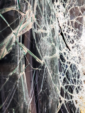 Car windshield shattered with stones by vandals.