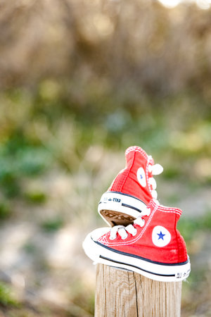 Valencia, Spain - March 3, 2019: Two red baby shoes from the Converse brand.のeditorial素材