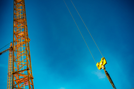 Detail of tower cranes isolated blue sky background.の写真素材