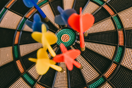 Center of a bullseye with colorful darts nailed, target concept.の写真素材