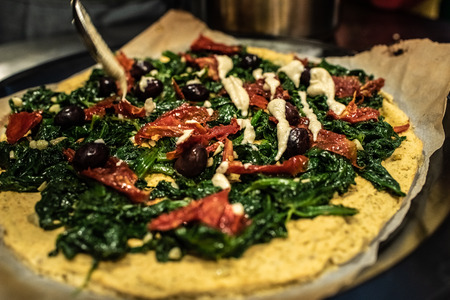 Preparing a pita sandwich with Kale and hummusの写真素材