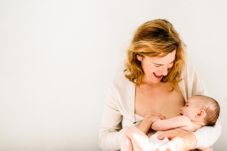 Pretty carefree baby happy with her mommyの写真素材