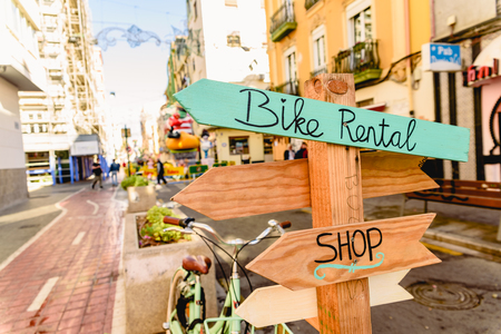 Wooden arrows as signposts of bicycle rental shop.の写真素材