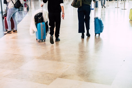 Valencia, Spain - March 8, 2019: Passengers with suitcases at an airport during vacations.のeditorial素材