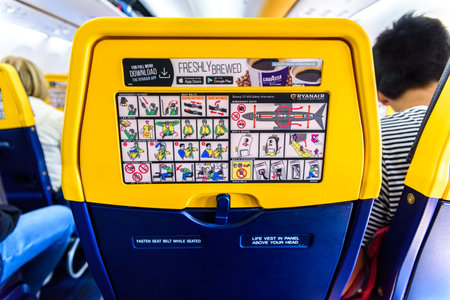 Valencia, Spain - March 8, 2019: Back of the seats of a Boeing plane with safety instructions,...
