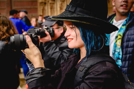 Valencia, Spain - April 6, 2019: Beautiful woman with blue dyed hair while taking a picture with a...