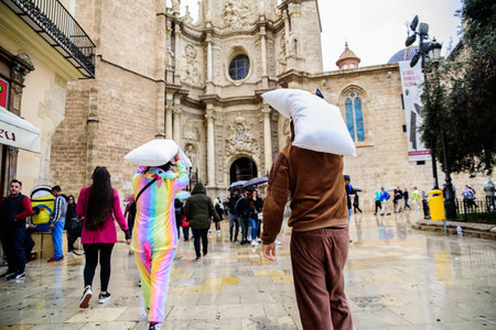 Valencia, Spain - April 6, 2019: Young people in disguise walking down the street towards a costume...