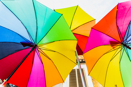 Colorful umbrellas to use as a background in bright and cheerful ideas.の写真素材