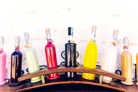 Alberobello, Italy - March 9, 2019: Drinks and liquors in bottles of traditional colors for sale for tourists.のeditorial素材