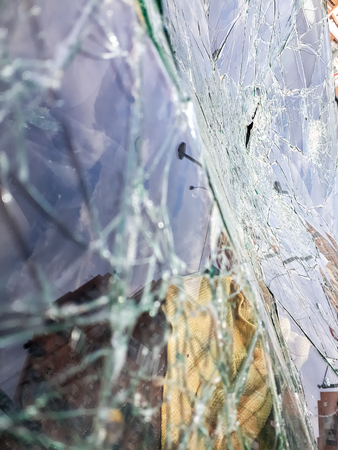Broken windshield of abandoned and destroyed car, with broken glass.の写真素材