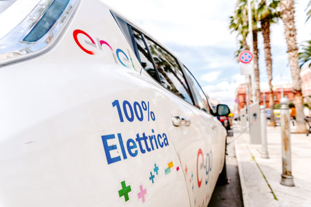 Bari, Italy - March 12, 2019: A 100% electric car from the Nissan brand is recharged on the street in a free recharge station by Enel in Italy.のeditorial素材