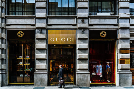 Bari, Italy - March 12, 2019: Gentleman in front of a Gucci shop window on a luxurious avenue in Bari.のeditorial素材