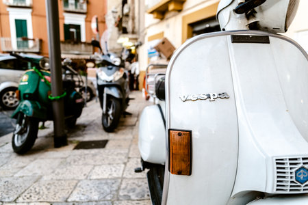 Bari, Italy - March 12, 2019: Old Vespa vintage motorcycles in use, parked on the streets of an old...