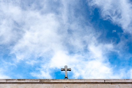 Christian cross on top of a church with a lot of blue sky copy space.の写真素材