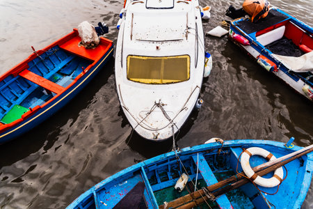 Bari, Italy - March 12, 2019: Old fishing boats moored to port dirty and in disuse.のeditorial素材
