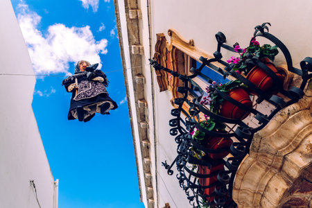 Locorotondo, Italy - March 9, 2019: Ancient ritual with witch-shaped dolls are suspended high across the streets of the Italian city of Locorotondo, on Easter, the witches are burned.のeditorial素材