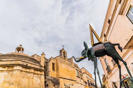 Matera, Italy - March 11, 2019: Replica of a sculpture of Dali, a deformed elephant, exposed on the street.のeditorial素材