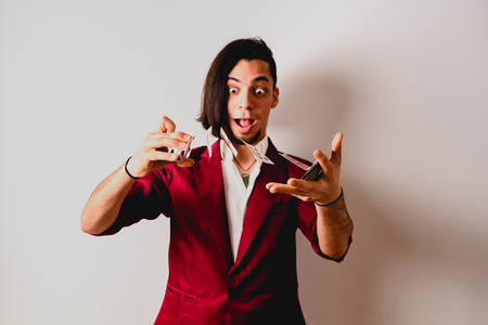 magician doing tricks with a deck of cards.