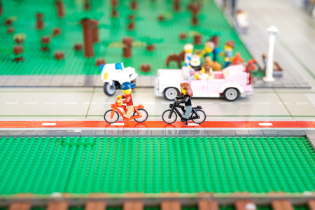 Valencia, Spain - April 3, 2019: Two Lego figures of urban cyclists walking through the city.