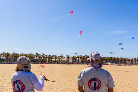 Valencia, Spain - May 12, 2019: Expert kite pilots during a flight display on the beach.のeditorial素材