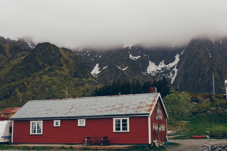 Nusfjord, Norway - May 28, 2015: Dried codfish hanging from the facade of a house in a fishing village.のeditorial素材