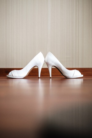 Vertical image of a white women's shoes with high heels.の写真素材
