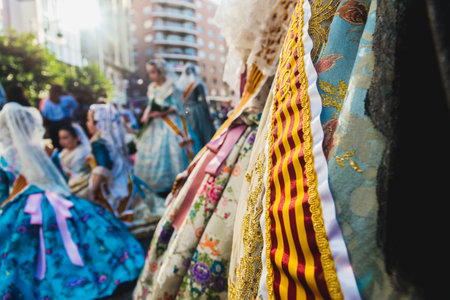 Valencia, Spain - March 17, 2019: Banda and Valencian flag decorating the typical Valencian fallera dress, worn by the beautiful women of Fallas.のeditorial素材