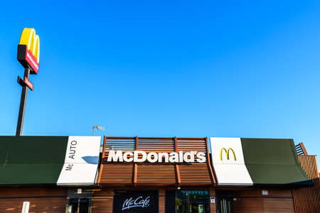 Valencia, Spain - May 29, 2019: Facade and roof of a fast food restaurant of the American franchise McDonalds in Spain, McAuto door.のeditorial素材