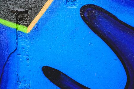 Detail of an anonymous street graffiti with many colors, cheerful urban background.