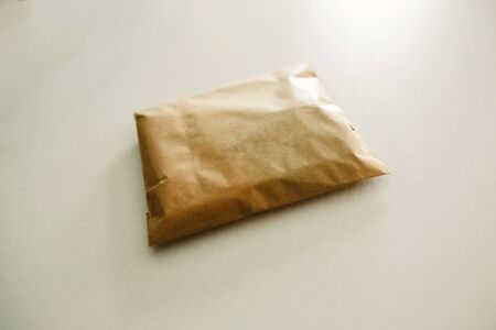 A small stuffed package on a white table.の写真素材