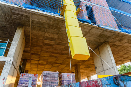 Valencia, Spain - July 3, 2019: Pipes to throw  debris into a construction site.のeditorial素材