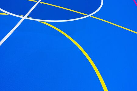 Background with cement texture painted blue, with white curved lines of a minimalist pattern with copy space.の写真素材