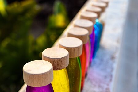 Group of bottles of calm anti stress, therapy to control stress and nerves of alternative education, filled with colored liquids to observe and relax.の写真素材