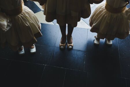 Legs of women with party shoes.