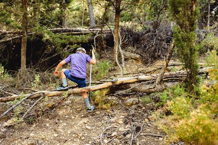 Child hiker walks on his back through the mountains.