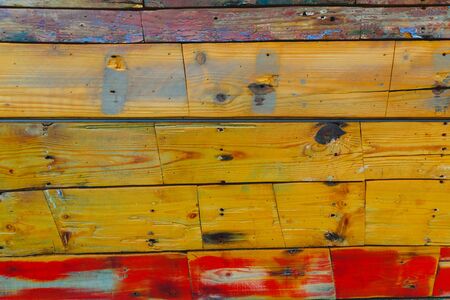 Painted wooden boards of various colors aged, natural texture background.の写真素材