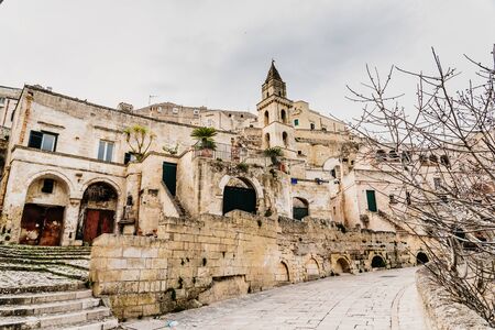 Long panoramic views of the rocky old town of Matera with its stone roofs.
