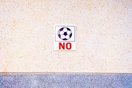 Sign on the wall forbidden to play football with the ball.の写真素材