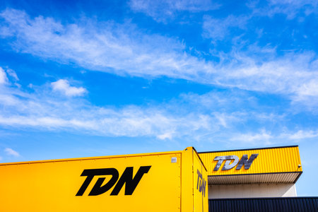 Valencia, Spain - July 30, 2019: Facade with logo of logistics companies and transport of goods by road with trucks such as TDN.のeditorial素材
