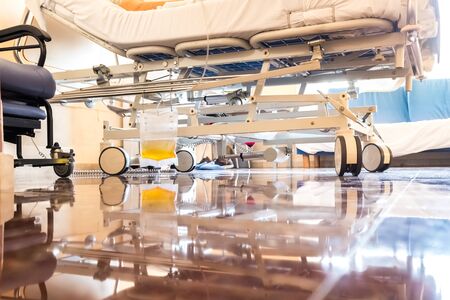 Hospital room with plastic bag hanging on a hospital bed to collect urine after an operation.の写真素材