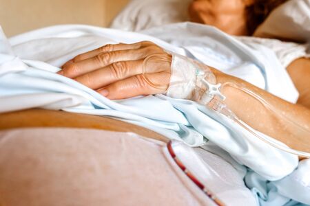 Intravenous cannula placed in the hand of an elderly patient for palliative care of a terminal patient.の写真素材