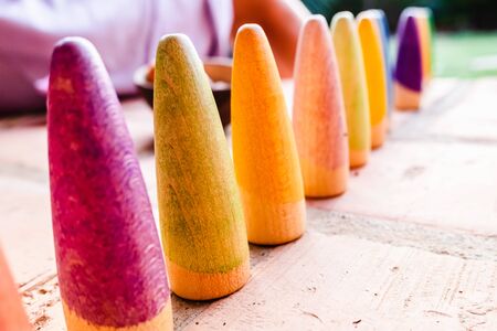 Toy set conical pieces of wood painted in colors for unstructured children's games.の写真素材