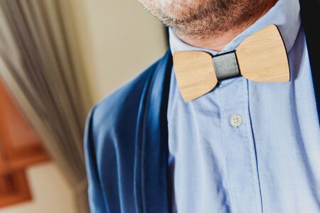 Purple male bow tie on a bed.の写真素材