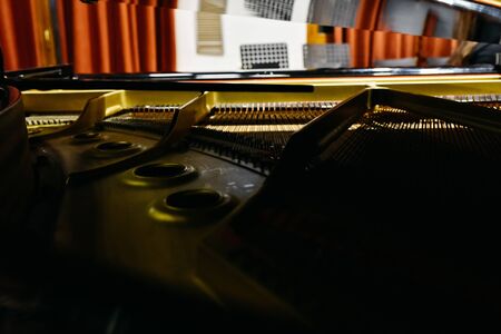 Detail of the interior of a piano with the soundboard, strings and pins.の写真素材