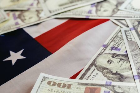 Stack of 100 dollar bills on american flag.の写真素材