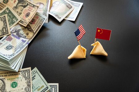 concept of commercial war between USA and China, with dollar bills and flags of the capitalist countries and biscuit.の写真素材
