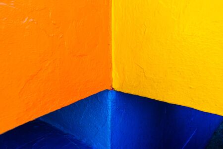 Abstract background of variable geometry and intense yellow and blue colors.